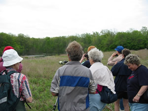 A group of birdwatchers at Loblolly Marsh looking at the Woodie Retreat.